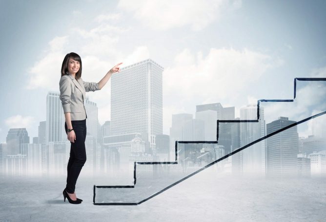 Business person in front of a staircase, city on the background